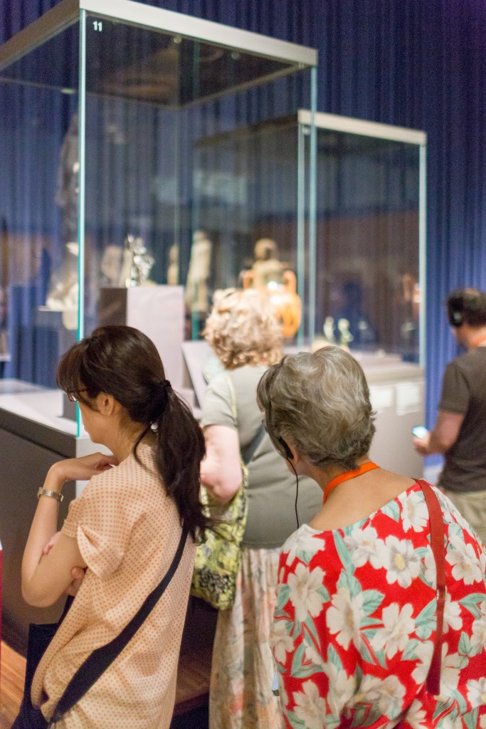 Visitor tries to navigate a crowd to get to a display