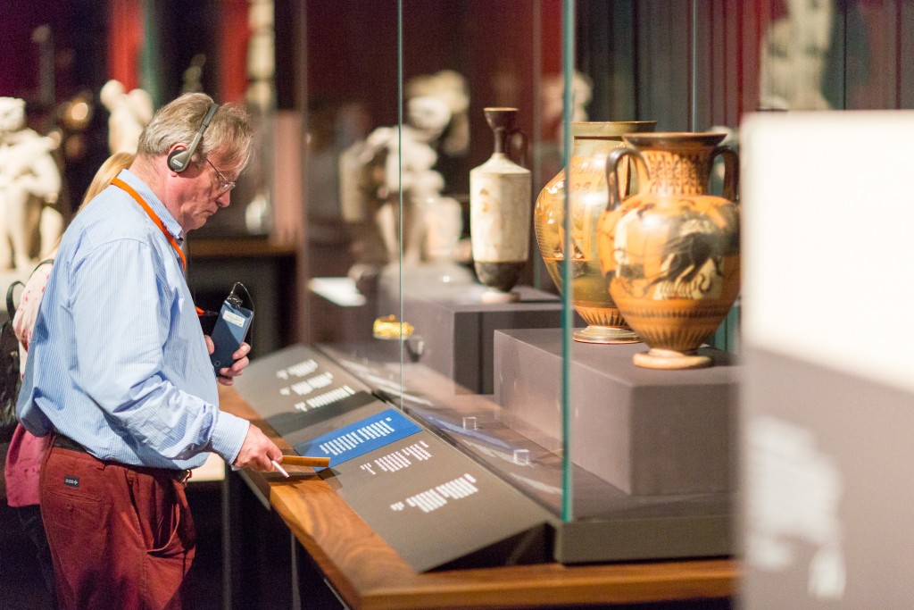 Visitor looks carefully at an object label