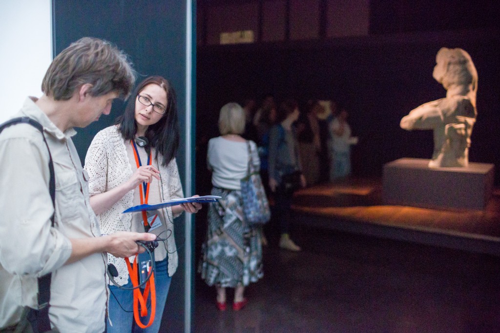 Researcher interviews visitor with audio guide