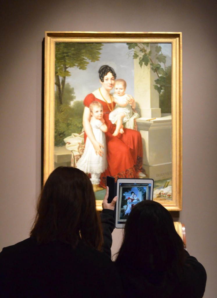 Figure 1: Teens testing augmented reality in SAM collection galleries. Mme. H and Her Children,1815. Louis André Gabriel Bouchet. Oil on canvas, 65 1/8 x 48 1/4 in.Seattle Art Museum, Eugene Fuller Memorial Collection, 62.75. Photo: Brenna Darroch. 