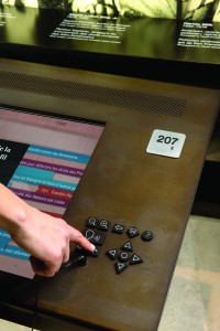 The UKP-I is a tactile button pad that facilitates navigation of a digital interface.