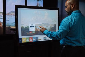 A user engages with the multitouch wall interactive, Landscapes Carry Meaning.