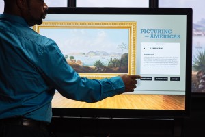 A user engages with the multitouch wall interactive, Landscapes Carry Meaning.